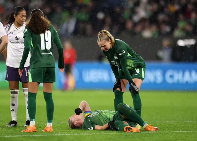 Popp lies on the floor holding her knee