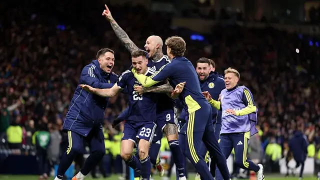 Scotland players celebrate with Kenny McLean after his goal