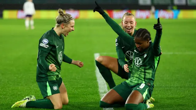 Beerensteyn points to the sky after knee sliding to celebrate her second goal