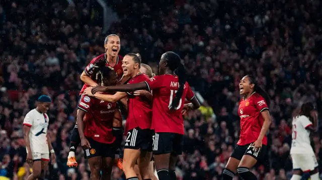 United players celebrate with Malard after her goal v PSG