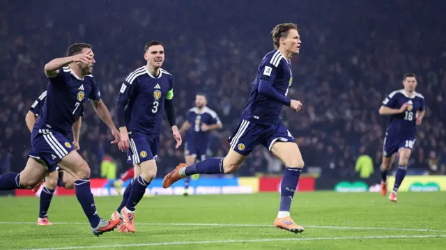Scott McTominay runs off in celebration after scoring for Scotland against Denmark