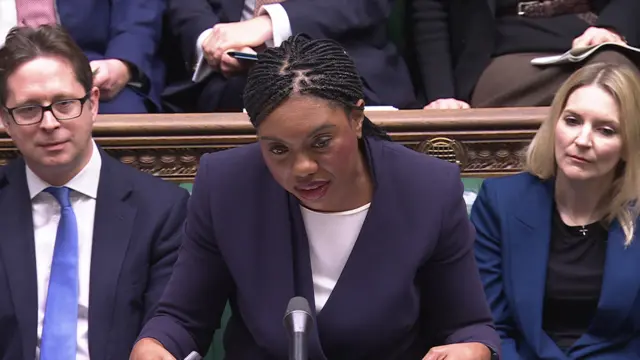 Kemi Badenoch stands at the dispatch box in the House of Commons.