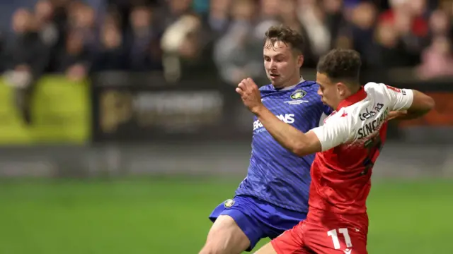 Gainsborough Trinity's Bobby Johnson and Accrington Stanley's Isaac Sinclair battle for the ball