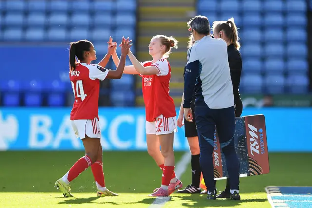 Taylor Hinds of Arsenal high fives her teammate Jenna Nighswonger as she is substituted off during the Barclays Women's Super League match between Leicester City and Arsenal at The King Power Stadium on November 02, 2025 in Leicester, England.