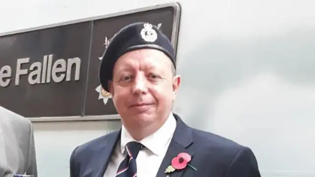 Andrew Johnson stands by an LNER train for the minute's silence to remember fallen soldiers