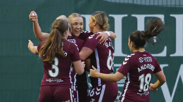 Georgia Timms (centre) is mobbed by teammates after making it 2-0