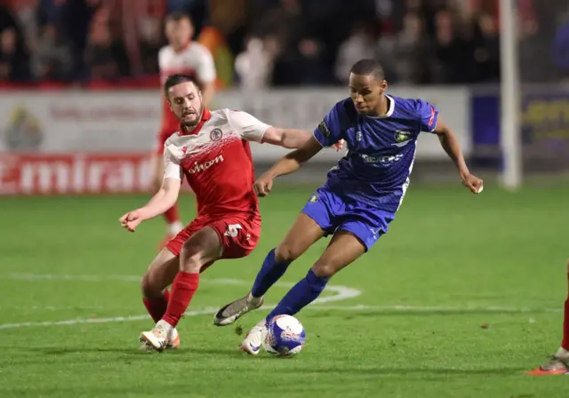 Gainsborough Trinity's Sisa Tuntulwana and Accrington Stanley's Liam Coyle battle for the ball