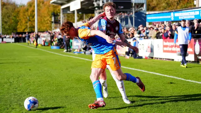 Shrewsbury Town's Tommy McDermott (front left) and South Shields' Caden Kelly battle for the ball