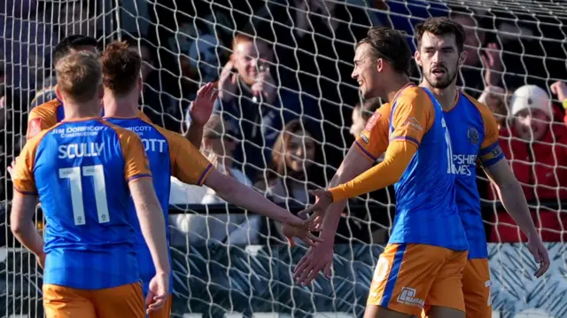 Shrewsbury Town players celebrate Tom Sang's goal