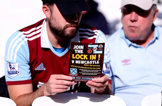 West Ham United fans with a flyer advertising a sit in / lock in protest
