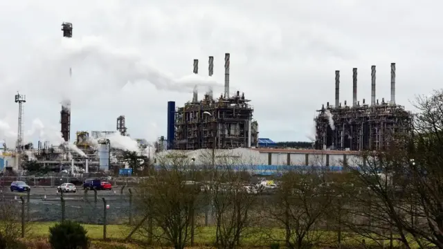 Exxon Mobil plant at Mossmorran with smoke plumes rising up in the sky