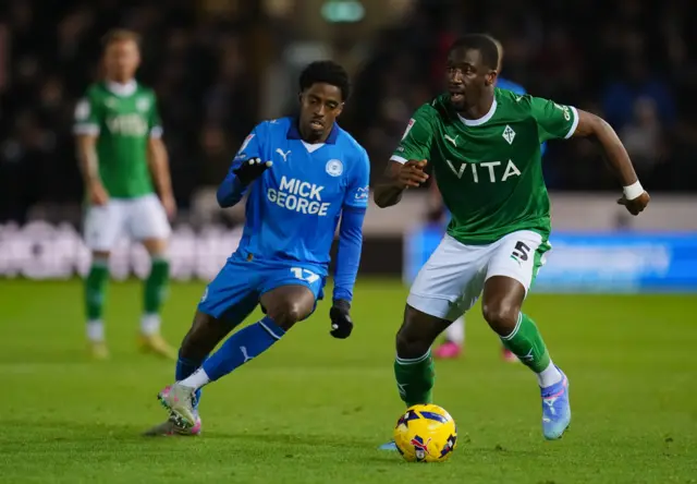 Kyrell Lisbie of Peterborough United and Joseph Olowu of Stockport County