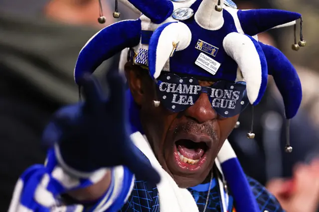 Basil the Chelsea fan waves decked in club gear