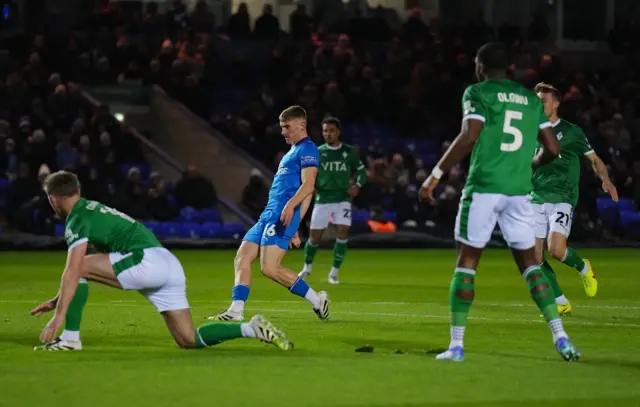 Ben Woods of Peterborough United scores a goal past Stockport County goalkeeper Ben Hinchliffe