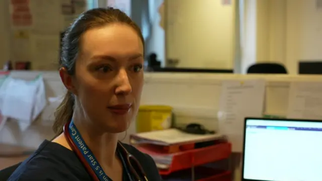 Lily Hiley next to a computer screen