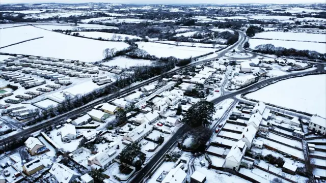 Drone shot of Pembrokeshire town covered in snow