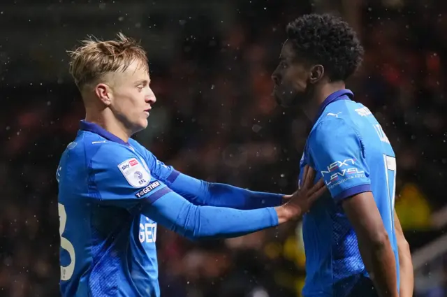 Peterborough players celebrate a goal against Stockport