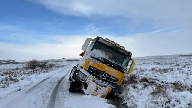 A truck stranded at the side of a road