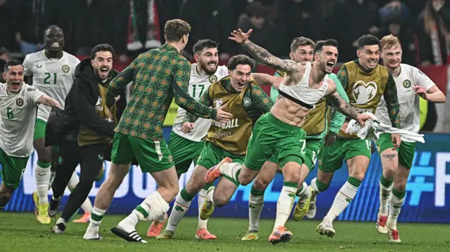 Republic of Ireland players celebrate with Troy Parrott after his winning goal against Hungary.
