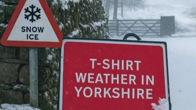 A road sign with T-SHIRT WEATHER IN YORKSHIRE written in white on a red background. A snow and ice sign is behind it.