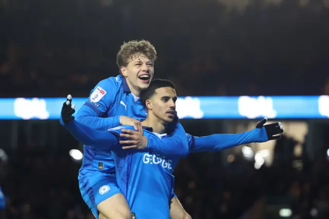 Peterborough United midfielder Brandon Khela (8) celebrates with Peterborough United forward Gustav Lindgren (19)