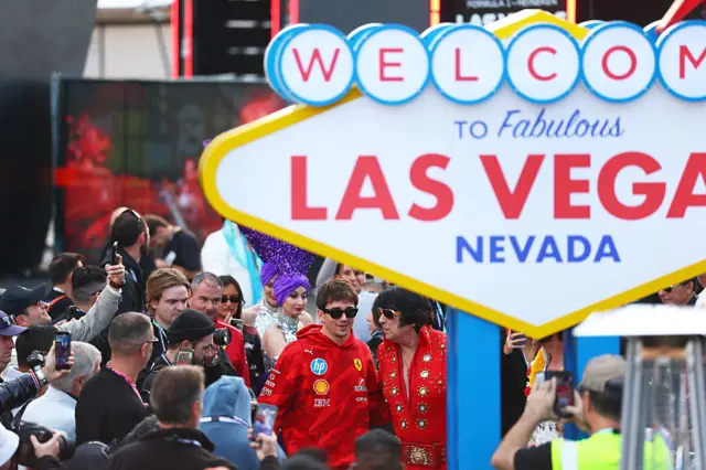 Charles Leclerc arrives in the Paddock prior to practice for the F1 Grand Prix of Las Vegas and is greeted by an Elvis Presley impersonator