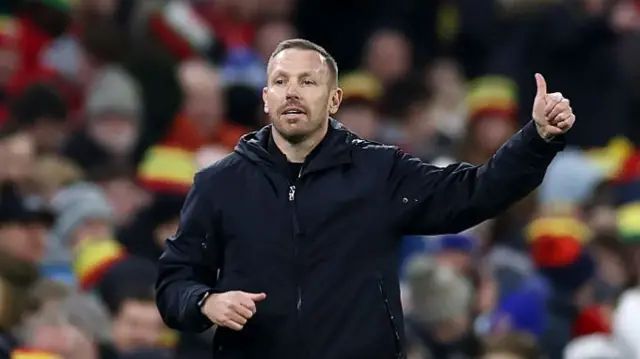 Craig Bellamy gives a thumbs up from the sideline suring Wales match against North Macedonia
