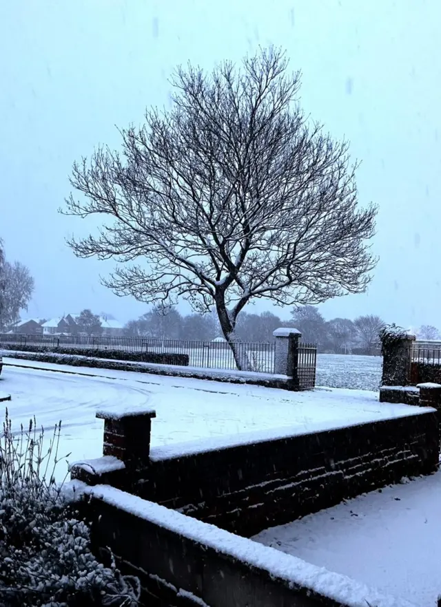 Snow covering a playground and a field