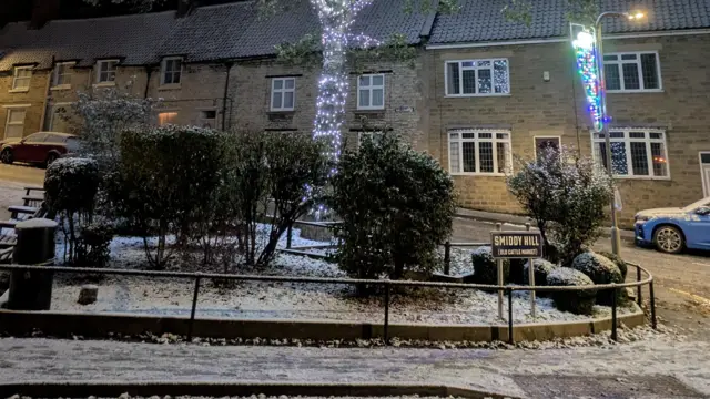 Footpaths and roads appear to be covered in a thin blanket of snow