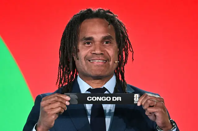 French former player Christian Karembeu shows the paper slip