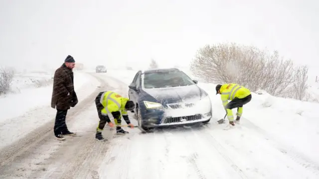 A car stuck in the snow on the A169 on the North York Moors