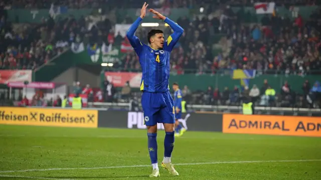Tarik Muharemovic of Bosnia and Herzegovina urges on the fans of Bosnia and Herzegovina during the FIFA World Cup 2026 European Qualifier Group H match between Austria and Bosnia and Herzegovina
