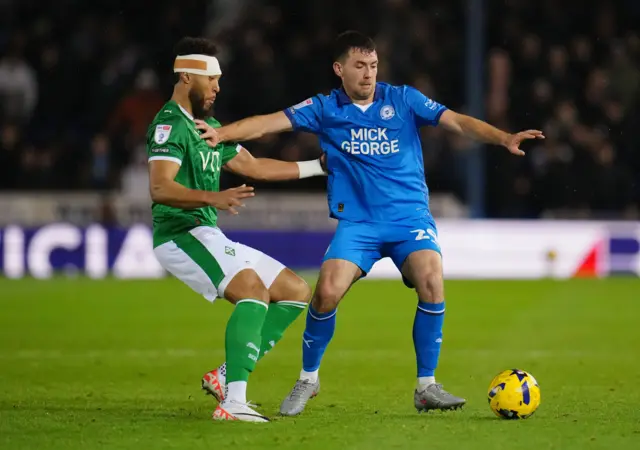 Kyle Wootton of Stockport County and Tom O'Connor of Peterborough United