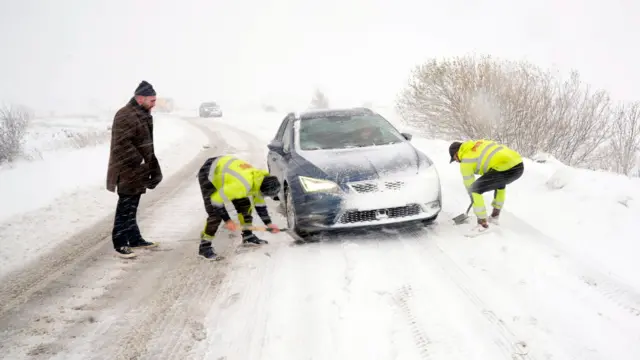 A car stuck on a snowy road in the North York Moors