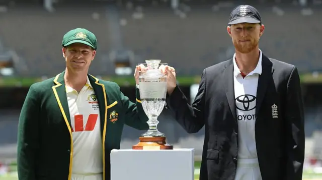 Steve Smith (left) and Ben Stokes (right) holding the Ashes trophy