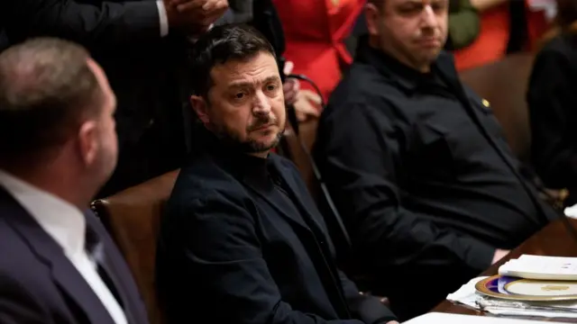 Zelensky is seen staring off into the distance
