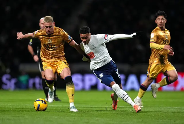 Blackburn Rovers' Lewis Miller (left) and Preston North End's Lewis Dobbin (centre) battle for the ball