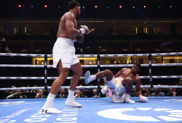 Anthony Joshua stands over Francis Ngannou