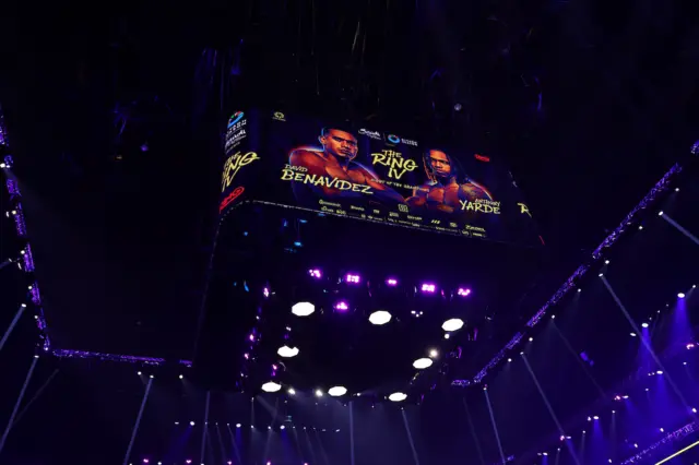A large screen above a boxing ring showing David Benavidez and Anthony Yarde