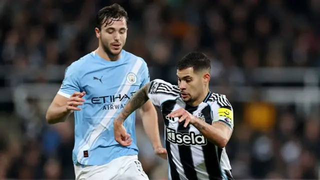 Bruno Guimaraes of Newcastle United is put under pressure by Nico Gonzalez of Manchester City during the Premier League match between Newcastle United and Manchester City at St James' Park on November 22, 2025 in Newcastle upon Tyne, England.