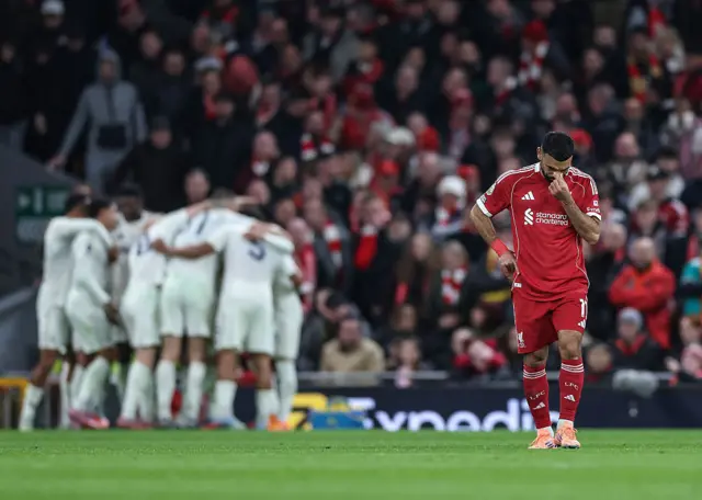 Liverpool's Egyptian striker #11 Mohamed Salah (R) reacts as Nottingham Forrest players (back L) celebrate after their third goal during the English Premier League football match between Liverpool and Nottingham Forest at Anfield in Liverpool, north west England on November 22, 2025.