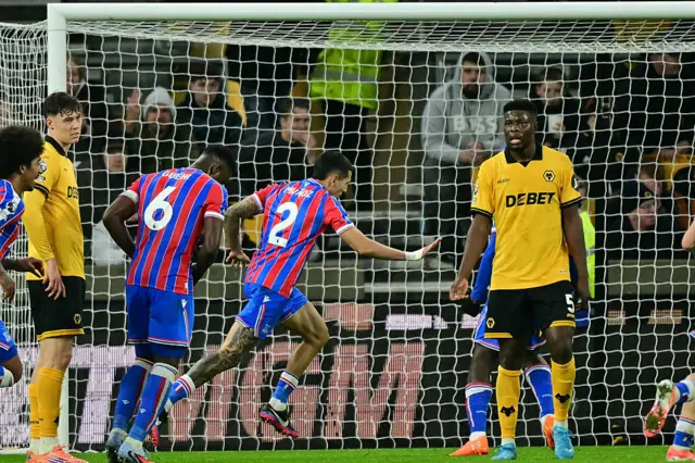 Crystal Palace's Colombian defender #02 Daniel Munoz celebrates after scoring the opening goal of the English Premier League football match between Wolverhampton Wanderers and Crystal Palace at the Molineux stadium in Wolverhampton, central England on November 22, 2025.