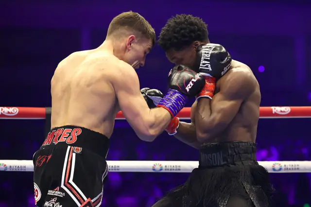 Abdullah Mason (R) blocks a punch thrown by Sam Noakes