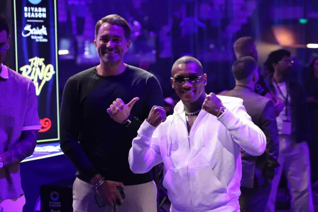 Eddie Hearn points his thumb at Conor Benn who is holding up his fists
