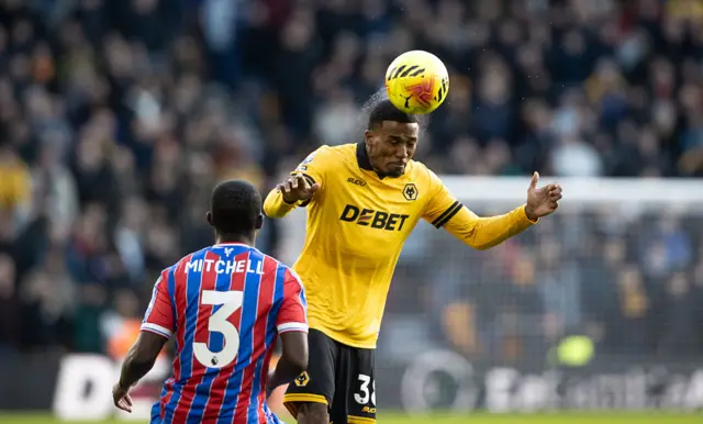 Wolverhampton Wanderers' Jackson Tchatchoua competing with Crystal Palace's Tyrick Mitchell during the Premier League match between Wolverhampton Wanderers and Crystal Palace at Molineux on November 22, 2025 in Wolverhampton, England.