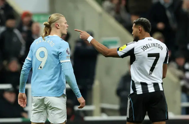 Manchester City's Erling Haaland clashes with Newcastle United's Joelinton