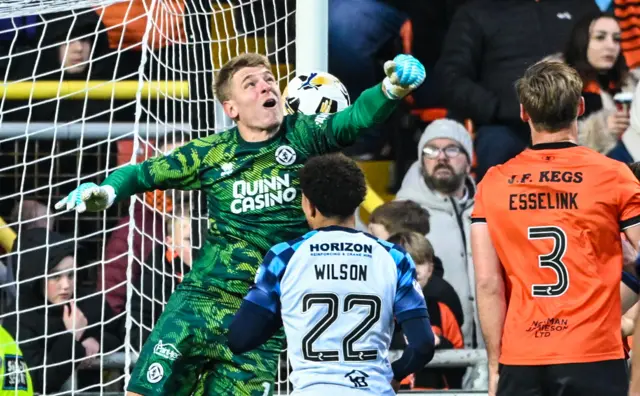 Yevhen Kuchurenko punches the ball into his own net