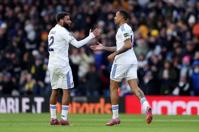 Lukas Nmecha of Leeds United celebrates scoring his team's first goal with teammate Jayden Bogle during the Premier League match between Leeds United and Aston Villa at Elland Road on November 23, 2025 in Leeds, England.