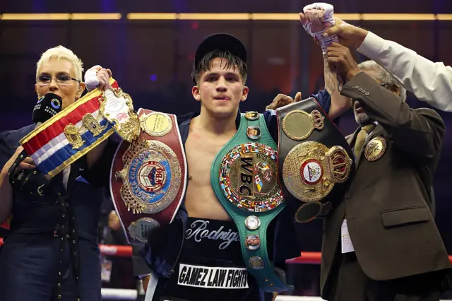 Jesse Rodriguez celebrates with his belts