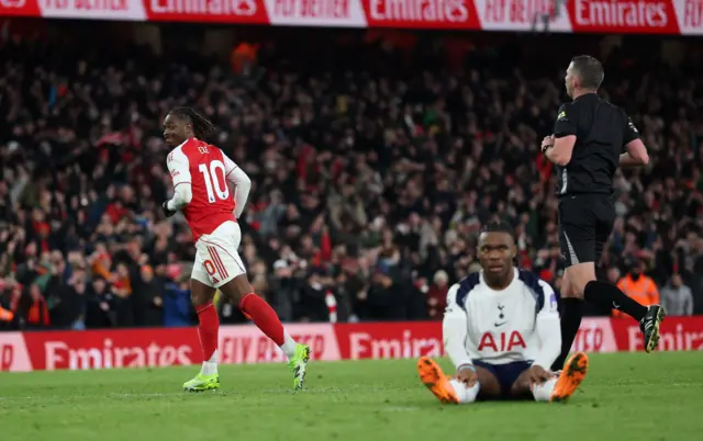 Arsenal's Eberechi Eze celebrates scoring their fourth goal as Tottenham Hotspur's Destiny Udogie looks dejected